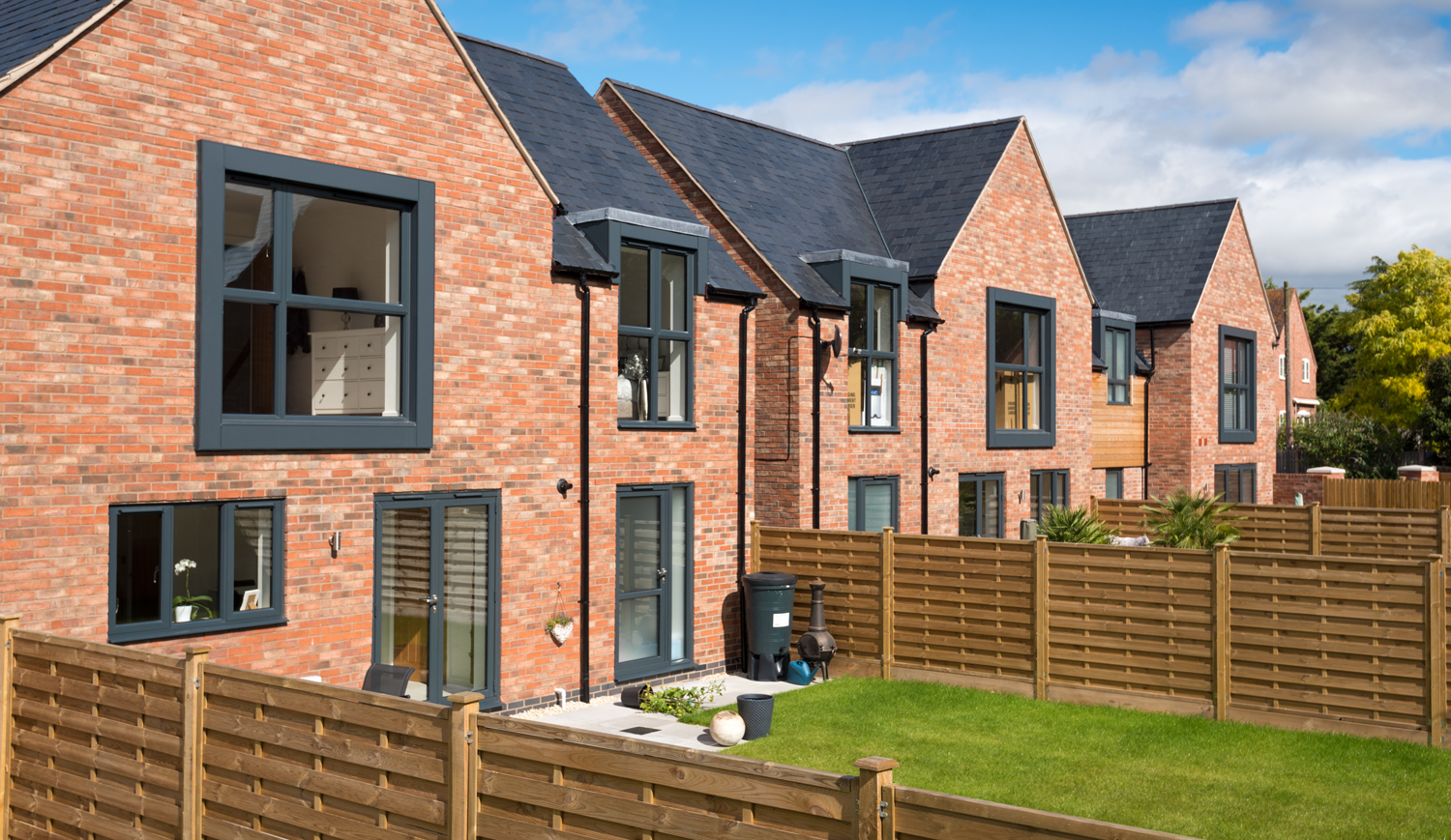 A row of houses from the view of their garden