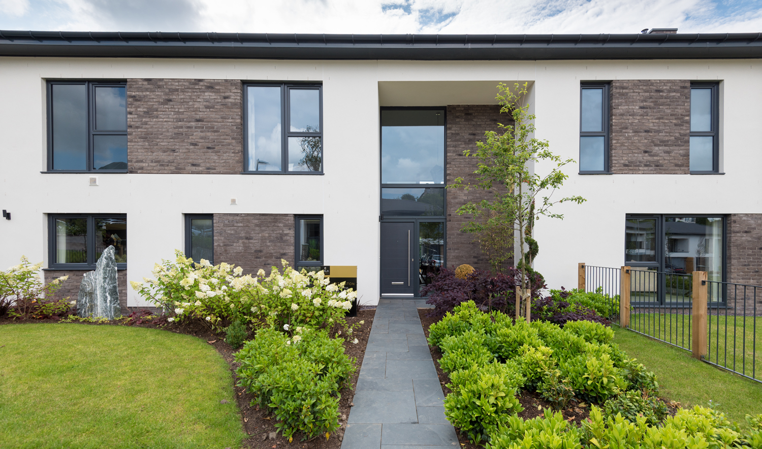 Wide view of the front of a modern house with Origin windows and front doors