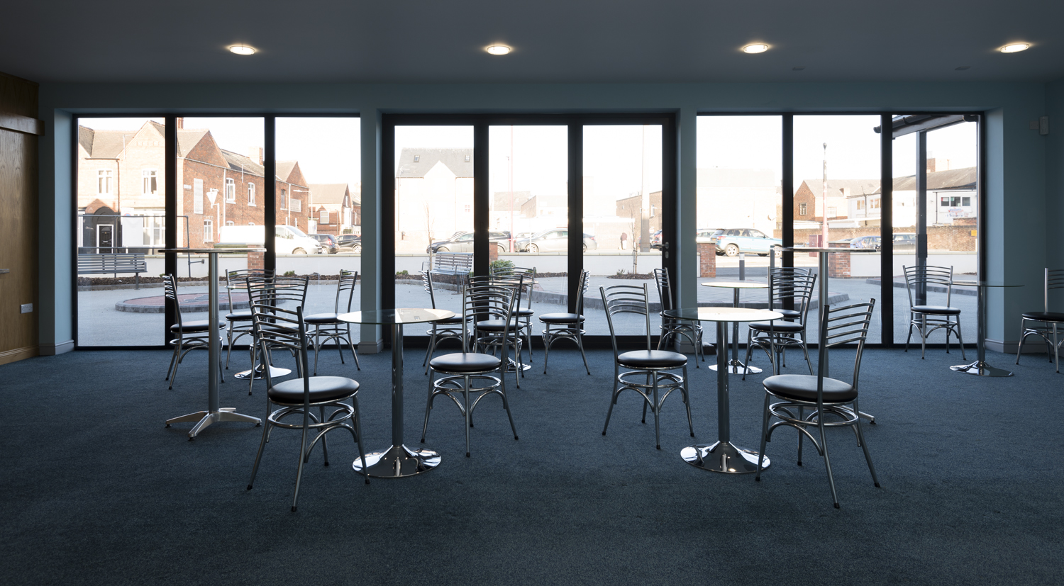 Indoor view leading out to the front road with tables and chairs