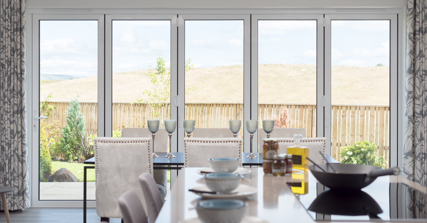 View of a set dining table with closed bifold doors