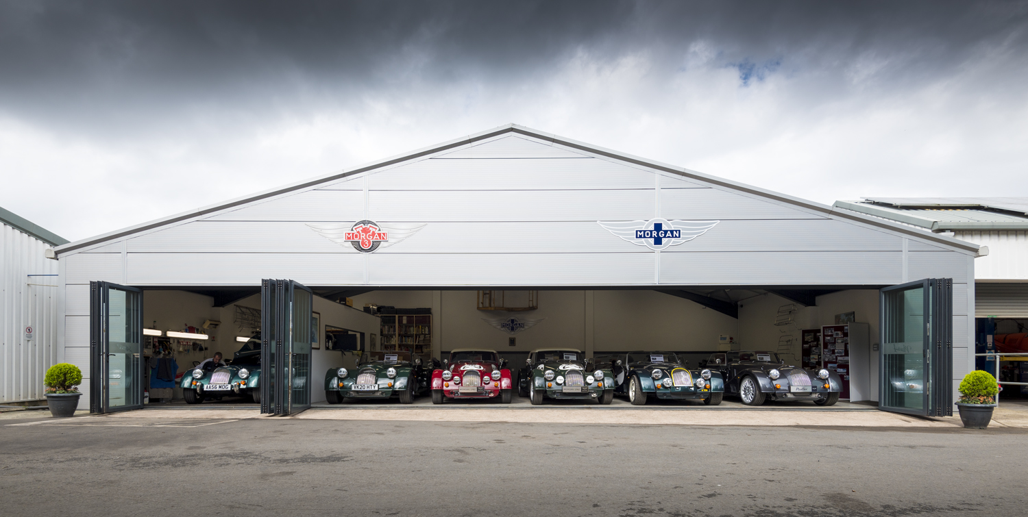 Open bifold doors at the front of a car showroom