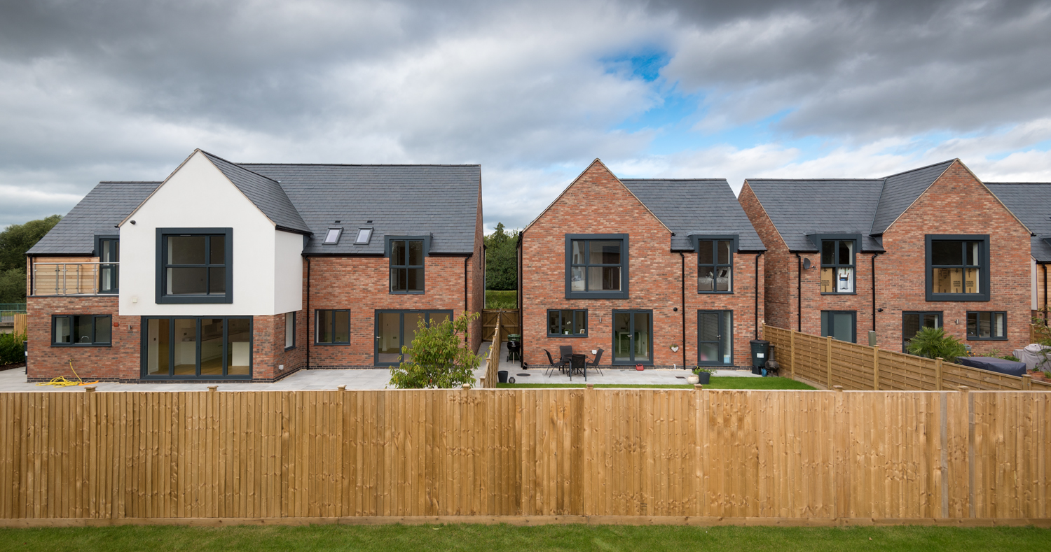 Back gardens of modern housing with Origin windows