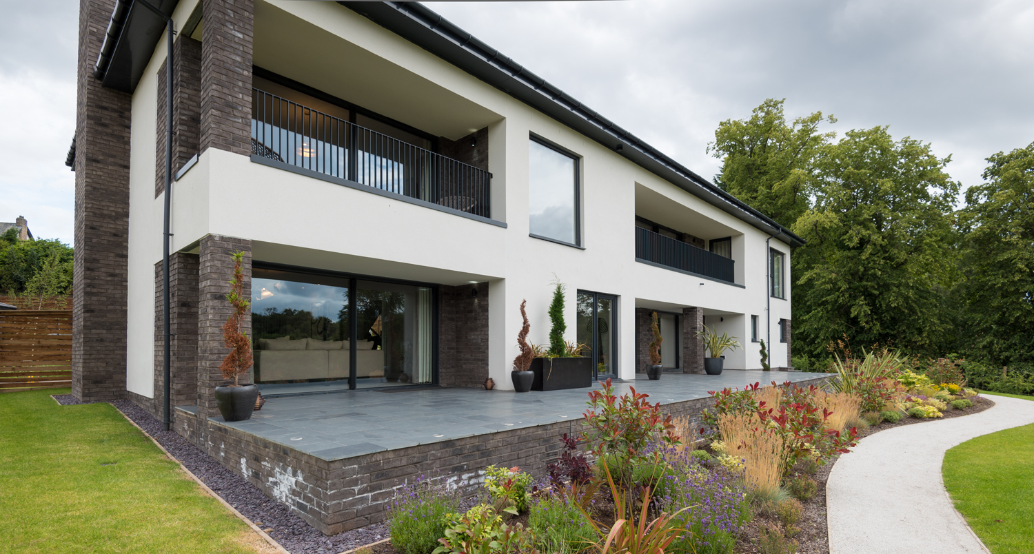 Wide view of a large modern house fitted with Origin bifold doors and windows