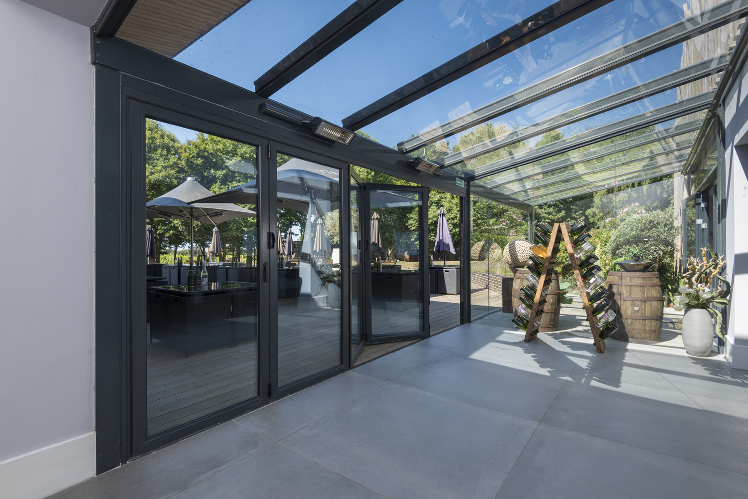 Inside of a bar viewing the bar garden through open bifold doors