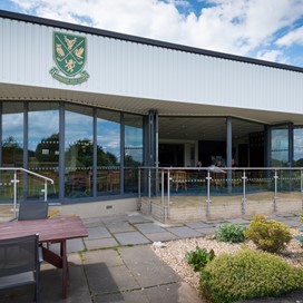 Open bifold doors of a golf club bar from an outdoor view