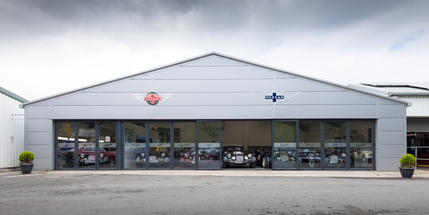 Half open bifold doors at the front of a car showroom