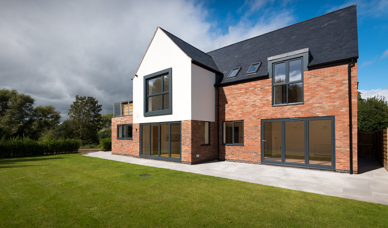 Side view of a large modern house from the view of the garden