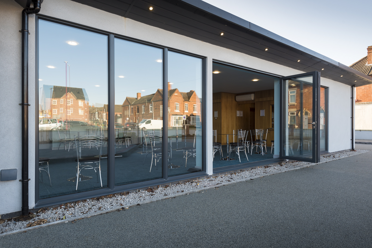 Open Bifolds leading into a room of tables and chairs