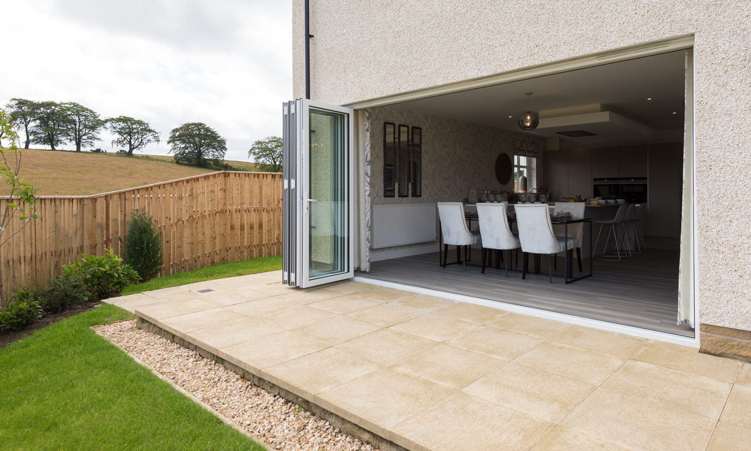 View from the garden into a modern house through bifold doors